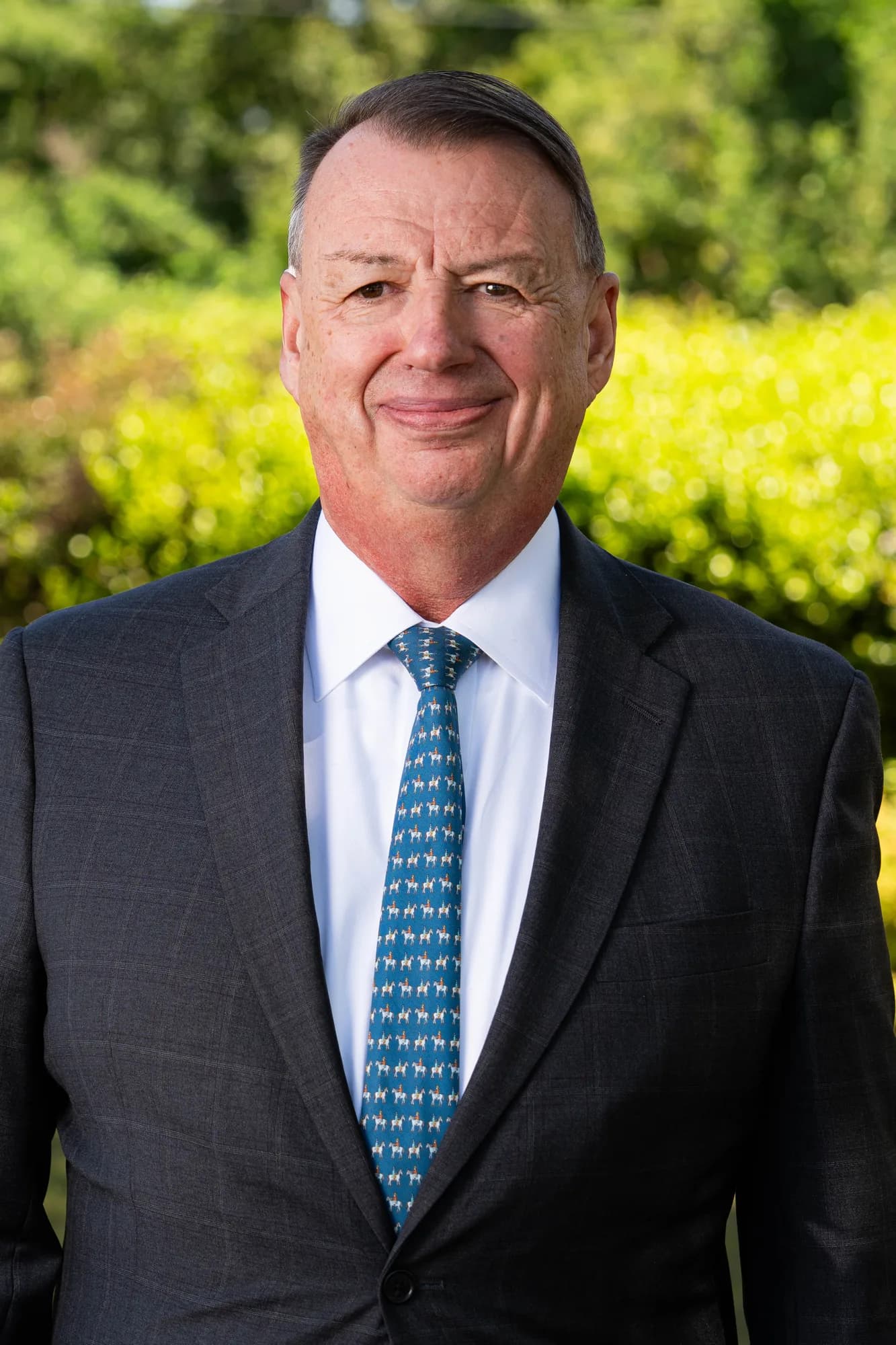 Portrait of Andrew Lacey in a suit outdoors