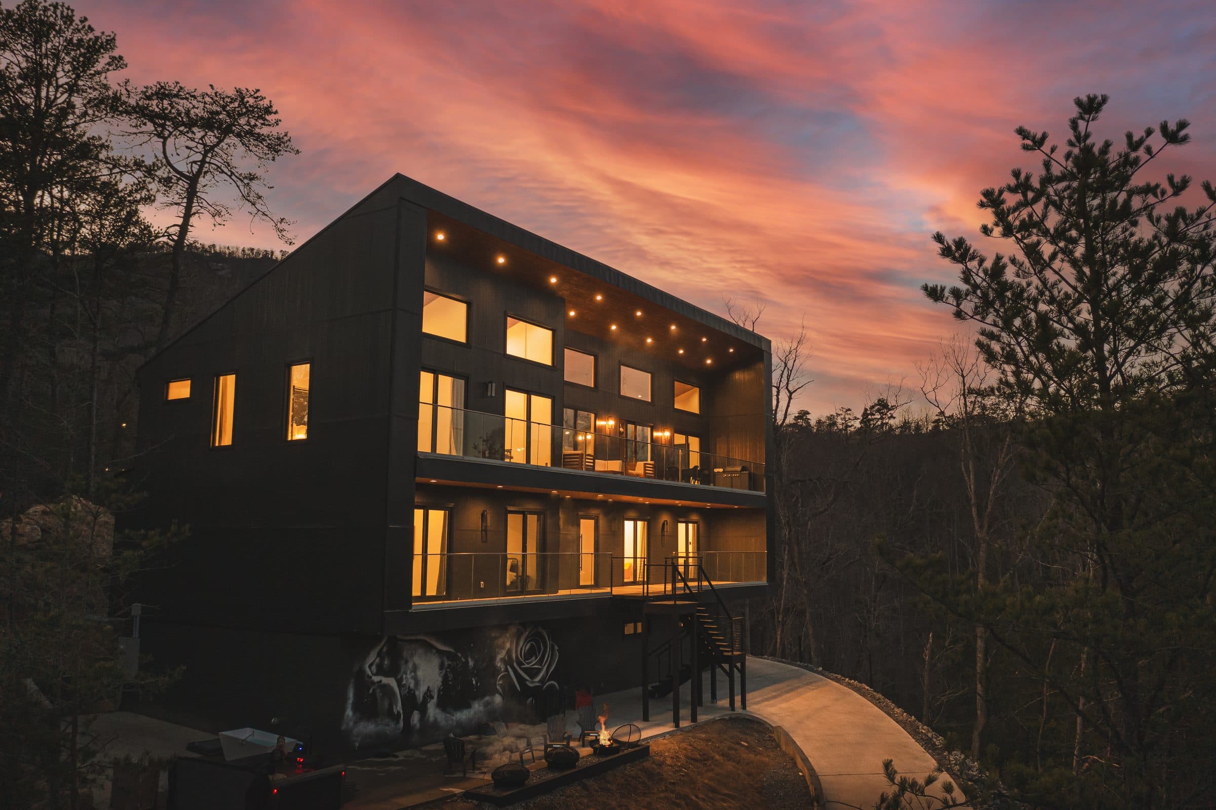 A modern home lit up at twilight